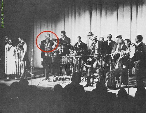 River City Blues Festival at Ellis Auditorium in Memphis, TN, December 3, 1971; l to r: Fred McDowell, Mrs. Van Hunt, Sweet Charlene, Willie '61' Blackwell, Mose Vinson (at piano), Sam Clark, Willie Morris, Richard 'Hacksaw' Harney, Dewey Corley, Lee Baker (seated), Houston Stackhouse (partially obscured), Sleepy John Estes, Hammie Nixon, Earl Bell (face away from camera), Furry Lewis (seated), Bukka White, and assistant emcee T.R. The actual emcee, Nat D. Williams, is not pictured; Festival produced by Steve LaVere. source: Living Blues 7 (Winter 1971-72), p. 10; photographer: Jim Godown