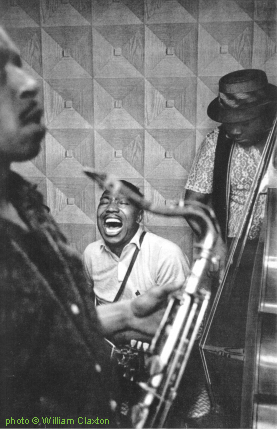 Tom Archia (ts), L E E   J A C K S O N (g) & Corky Roberts (b) at the 'Blues Party', a special event organized in Jump Jackson's garage 'studio', 5727 South La Salle Street, Chicago, IL, summer 1960; source: Joachim E. Berendt & William Claxton: Jazz Life - Auf den Spuren des Jazz.- Offenburg, Germany (Burda Druck und Verlag GmbH) 1961, p. 141; photographer: William Claxton