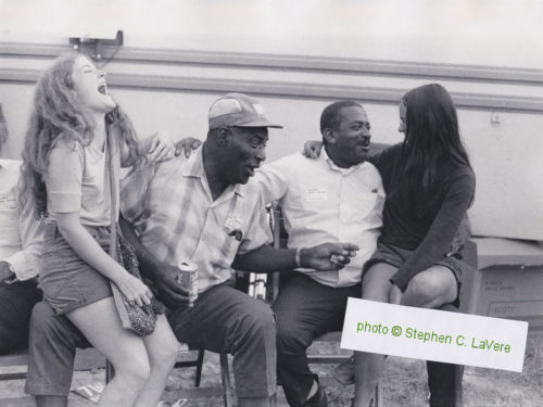 Howling Wolf & Papa Lightfoot with two young ladies (the one on Wolf's lap is -as it turned out- one 'Monica McCabe') at Ann Arbor Blues Festival, 1970; source: ebay auction; photographer: Stephen C. LaVere