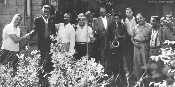 Lee Jackson, 'Clear Waters' (Eddie Clearwater), Little Brother Montgomery, Roosevelt Sykes, St. Louis Jimmy (Oden), Sunnyland Slim, Tom Archia, Corky Roberts, Armand 'Jump' Jackson, Shakey Jake (Harris) - all guests at the 'Blues Party', a special event organized in Jump Jackson's garage 'studio', 5727 South La Salle Street, Chicago, IL, summer 1960; source: Joachim E. Berendt & William Claxton: Jazz Life - Auf den Spuren des Jazz.- Offenburg (Burda Druck und Verlag GmbH) 1961, pp. 136-137; photographer: William Claxton