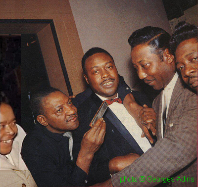 Hanging out in Muddy's basement at 4339 South Lake Park Avenue, Chicago, IL:James Cotton, Sonny Boy Williamson, Jimmy Rogers, Muddy Waters, Otis Spann (ca. 1960); source: Front page of Block - Tijdschrift voor Blues #85 (jan/feb/mrt '93); photographer: Georges Adins ('met dank aan Kees van Wijngaarden')