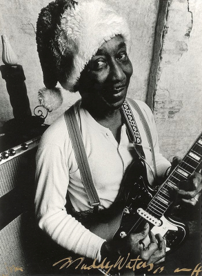 'Santa' Muddy Waters, 1969, holding a Fender 'Jaguar' guitar in front of a Fender rig; source: Ebay auction from Burt Goldblatt collection (Peter Amft 2002 Christmas card); photographer: Peter Amft