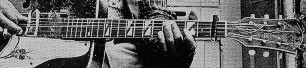 Big Joe Williams playing his nine-string guitar; enlargement of picture above; click to further enlarge !