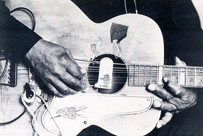 Big Joe Williams playing his nine-string guitar; source: Front cover of Stefan Grossman featuring Rory Block: How To Play Blues Guitar.- Kicking Mule KM 109; photographer: David Gahr; click to enlarge!