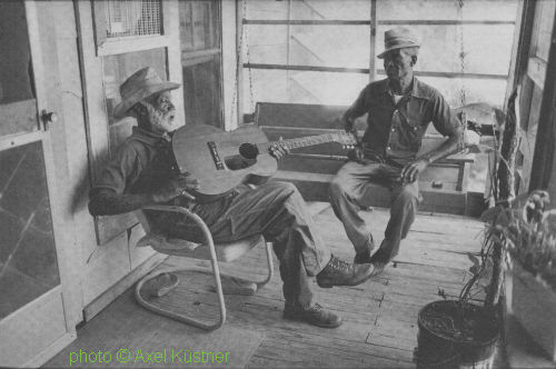 M O T T   W I L L I S and Charlie Taylor at Willis' home in Terry, north of Chrystal Springs, Mississippi, September 1978; source: Michael Rauhut & Reinhard Lorenz (ed.): Ich hab den Blues schon etwas länger - Spuren einer Musik in Deutschland.- Berlin (Christoph Links Verlag) 2008, p. 125; photographer: Axel Küstner